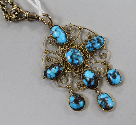 An early 20th century 9ct gold and turquoise set filligree pendant on a 9ct gold chain, pendant 5cm.